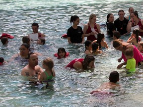 People take part in a free swimming lesson at the West Edmonton World Waterpark as part of a larger attempt to set a Guinness World Record for the world's largest swimming lesson happening at the same time around the world on Thursday June 22, 2017. There were 26 participants at the Edmonton event.