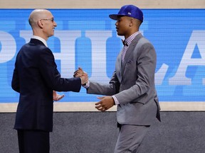 Markelle Fultz is greeted by NBA Commissioner Adam Silver after being selected first overall by the Philadelphia 76ers during the NBA draft on June 22, 2017. (AP Photo/Frank Franklin II)