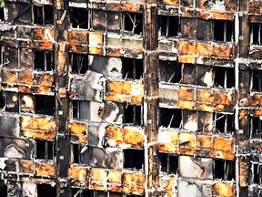 The charred remains of clading are pictured on the outer walls of the burnt out shell of the Grenfell Tower block in north Kensington, west London on June 22, 2017. AFP PHOTO / NIKLAS HALLE'NNIKLAS HALLE'N/AFP/Getty Images  BRITAIN-FIRE