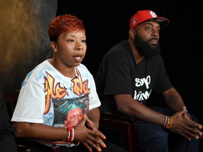 In this Sept. 27, 2014, file photo, the parents of Michael Brown, Lezley McSpadden, left, and Michael Brown Sr., sit for an interview with The Associated Press in Washington. The city attorney in Ferguson, Missouri, said Friday, June 23, 2017, that the city's insurance company paid $1.5 million to settle a lawsuit filed by the family of Michael Brown. (AP Photo/Susan Walsh, File)