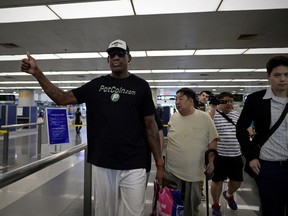 Former NBA basketball player Dennis Rodman of the US gestures as he arrives to check-in for his flight to North Korea at Beijing's international airport on June 13, 2017. (WANG ZHAO/AFP/Getty Images)
