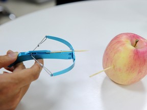 This photo taken on June 20, 2017 shows a man demonstrating a toothpick crossbow in Chengdu, in China's southwest Sichuan province. (STR/AFP/Getty Images)