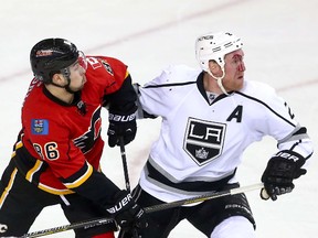 Calgary Flames forward Josh Jooris battles with Los Angeles Kings defenceman Matt Greene at the Scotiabank Saddledome in Calgary on Thursday, April 9 2015. (Darren Makowichuk/Calgary Sun)