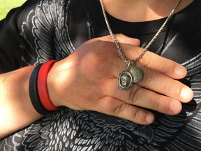 In this June 21, 2017 photo, Samantha "Sam" LaRochelle, shows a pendant that had belonged to her grandfather and a thumbprint in gold of her late mother, at her home in Lopatcong Township, N.J. The irreplaceable necklace had been removed from her neck during an emergency visit to St. Luke's Hospital in Phillipsburg on June 17, 2017. Staff at Covanta Energy Corp. in Oxford Township dug through a 15-ton pile of hospital waste to find it. (Kurt Bresswein/The Express-Times via AP)