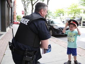 Jason Miller/The Intelligencer
Isaac Monkman, 3, borrows the hat of deputy Chief Mike Callaghan. Callaghan and Chief Ron Gignac have committed to reconnecting with the community.