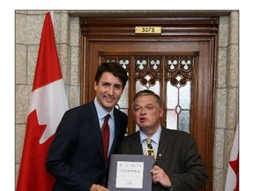 office of the prime minister
Prime Minister Justin Trudeau, with Kingston’s Arthur Milnes, is presented a copy of With Faith and Goodwill: 150 Years of Canada-U.S. Friendship, a project of the Canadian American Business Council for Canada 150 edited by Milnes and published by Dundurn.