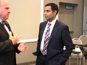 Bluewater Health board chair Wayne Pease, left, talks geriatric care strategy with expert Dr. Samir Sinha during a break at the board's annual general meeting. (NEIL BOWEN/Sarnia Observer)