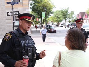 Jason Miller/The Intelligencer
Chief Ron Gignac (first from left) and deputy Mike Callaghan speak with citizens during a walkabout in downtown Belleville.