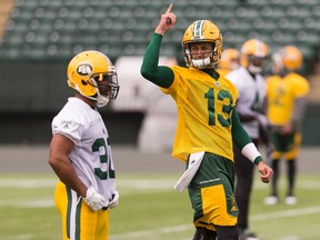 John White (left) and quarterback Mike Reilly are seen during Edmonton Eskimos practice at Commonwealth Stadium in Edmonton, Alberta on Thursday, June 22, 2017.