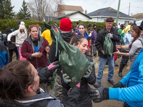 All sorts of volunteers are pitching in with sandbagging at Rue Saint-Louis and Rue Moreau in Gatineau as flooding continues throughout the region in areas along the local rivers.  (Wayne Cuddington/Postmedia)