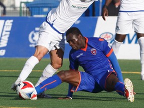 FC Edmonton  Mauro Eustaquio and Miami FC Kwadow Poku via for the ball during first half action at Clarke Park. June 10, 2017.