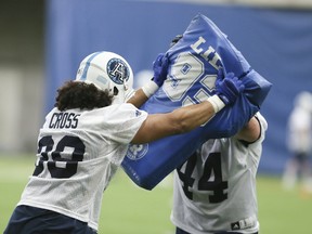 Toronto Argonauts Declan Cross (left) and James Tuck train hard 
for their upcoming season opener against the Ticats Sunday. (Veronica Henri/Toronto Sun)