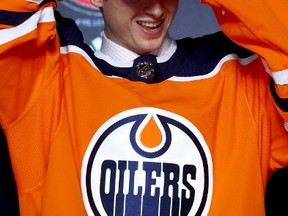 Kailer Yamamoto puts on the Edmonton Oilers hat after being selected 22nd overall during the 2017 NHL Draft at the United Center on June 23, 2017 in Chicago, Illinois.