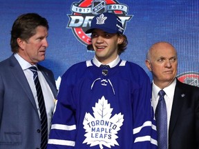 Timothy Liljegren (centre) poses for photos after being selected 17th overall by the Maple Leafs during the 2017 NHL Draft at the United Center in Chicago on Friday, June 23, 2017. (Bruce Bennett/Getty Images)