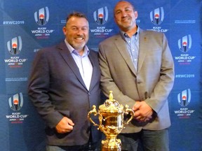Former Canada captains Gareth Rees (left) and Al Charron pose with the Webb Ellis Cup, which goes to the Rugby World Cup winner, in Toronto on June 21, 2017. The cup is in town to make the first leg of the Canada-U.S. World Cup qualifier in Hamilton, Ont. on June 24, 2017. (NEIL DAVIDSON/The Canadian Press)