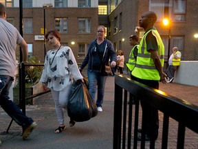 Residents are evacuated from the Taplow residential tower block on the Chalcots Estate, in the borough of Camden, north London, Friday, June 23, 2017. (AP Photo/Alastair Grant)