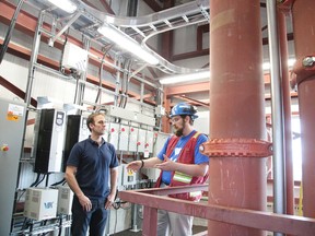 Alex Hutchison, right, a PhD Student at MIRARCO - Mining Innovation Rehabilitation and Applied Research Corporation gives a tour of the Hydraulic Air Compressor (HAC) Demonstrator at Dynamic Earth during the grand opening in Sudbury, Ont. on Wednesday June 21, 2017. Gino Donato/Sudbury Star/Postmedia Network