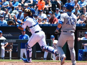 Salvador Perez #13 of the Kansas City Royals catches a ball on a bunt attempt by Luke Maile #22 of the Toronto Blue Jays in the fifth inning at Kauffman Stadium on June 24, 2017 in Kansas City, Missouri. (Photo by Ed Zurga/Getty Images)