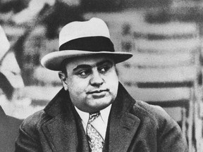 In this Jan. 19, 1931 file photograph, Chicago mobster Al Capone is seen at a football game in Chicago. Artifacts connected to some of the nation's most notorious gangsters are being auctioned this weekend. A handwritten musical composition by Al Capone, a letter written by a jailed John Gotti asking someone to "keep the martinis cold," and jewelry that belonged to Bonnie and Clyde are among the items up for bid Saturday in the "Gangsters, Outlaws and Lawmen" auction in Cambridge, Mass. (AP Photo/File)