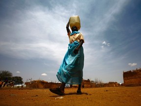 A South Sudanese woman walks at Al-Nimir refugee camp in Sudan's east Dafur on June 20, 2017. South Sudan, which split from the north in 2011, has declared famine in parts of the country, saying a million people are on the brink of starvation.