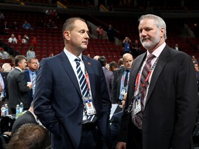 Calgary Flames general manager Brad Treliving and New York Islanders general manager Garth Snow meet during 2017 NHL Draft at the United Center on June 24, 2017 in Chicago, Illinois. (Photo by Bruce Bennett/Getty Images)