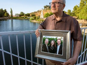 In this Friday, June 23, 2017 photo, Frank Kerrigan holds onto a photograph of his three children John, Carole, and Frank, near Wildomar, Calif. Kerrigan, who thought his son Frank had died, learned he buried the wrong man. Kerrigan said the Orange County coroner's office mistakenly identified a body found dead on May 6 as that of his son. (Andrew Foulk/The Orange County Register via AP)
