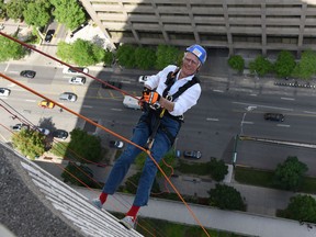 Gordon Cheong/For The Star. 
Columnist Dr. Gifford-Jones descends from the top of Toronto’s City Hall on a rope.