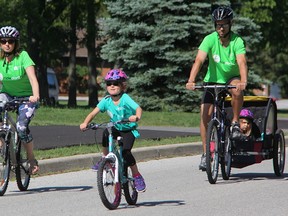 Six-year-old Reese Kremer rides into the Mooretown Sports Complex with her mother Cindy, father Dennis, and sister Dylan, 3, during the annual Canadian Mental Health Association (CMHA) Lambton-Kent Ride Don't Hide event Sunday. About 270 riders took part. Tyler Kula/Sarnia Observer/Postmedia Network