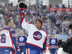 Former Winnipeg Jet Teemu Selanne (13) waves to the crowd at Investors Group Field prior to the first period of the NHL Heritage Classic Alumni game in Winnipeg on Saturday, October 22, 2016. (THE CANADIAN PRESS/John Woods)