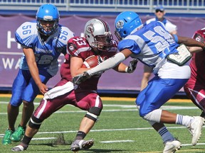 Limestone District Grenadier Keegan Wardhaugh comes into contact with Cumberland Panthers Shawn Charles during the first quarter of Ontario Provincial Football League action at Richardson Stadium in Kingston, Ont. on Saturday June 24, 2017. The Grenadiers defeated the Panthers 46-28. Steph Crosier/Kingston Whig-Standard/Postmedia Network