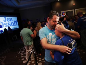 Matthew Levy, left, comforts his wife Sheila Levy after Democratic candidate for 6th congressional district Jon Ossoff conceded to Republican Karen Handel at his election night party in Atlanta, Tuesday, June 20, 2017. (AP Photo/David Goldman)
