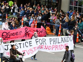 Black Lives Matter protesters block the Twin Cities Pride Parade along Hennepin Ave at the start of the parade in Minneapolis, Sunday, June 25, 2017. Sunday's parade was disrupted over the police shooting of Philando Castile just minutes after getting underway in downtown Minneapolis. (Glen Stubbe/Star Tribune via AP)