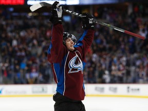 Colorado Avalanche center Matt Duchene raises his stick in the air to celebrate after scoring the tying goal against the Tampa Bay Lightning in the third period of an NHL hockey game, Sunday, Feb. 19, 2017, in Denver. (AP Photo/David Zalubowski)
