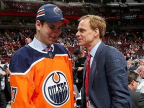 Niagara IceDogs forward Kirill Maksimov, left, meets Edmonton Oilers executive Scott Howson after being selected 146th overall in the fifth round of the NHL Entry Draft Saturday in Chicago.