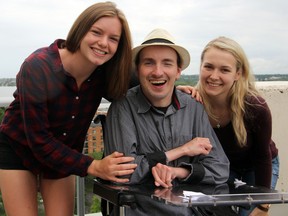 Kendra Clark, James McNutt and Hannah Brockwell pose for a photo on Friday. McNutt, who has a severe form of cerebral palsy, requires a caregiver 24 hours a day. (Steph Crosier/The Whig-Standard)