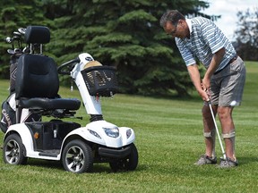 Allen Henschel, who has MS still plays golf and has a scooter which he uses to transport him around the course  in Edmonton, June 23, 2017.