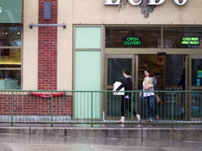 Shoppers leave LCBO on Wellington Street West on Sunday after stocking up in case of a labour dispute. ASHLEY FRASER /OTTAWA CITIZEN