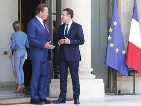 French President Emmanuel Macron speaks with US actor and founder of the R20 climate action group Arnold Schwarzenegger after their meeting on June 23, 2017 at the Elysee Palace in Paris.(GEOFFROY VAN DER HASSELT/AFP/Getty Images)