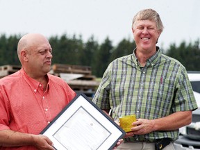 Chatham-Kent councillor Leon Leclair presents DVS Farms Ltd.'s Dave VanSegbrook with the Wallaceburg and District Chamber of Commerce's bi-annual feature industry recognition certificate on Thursday, June 22.