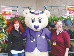 Dr. Patchup with Deb Mayer, Stollery Fund Development Officer and Walmaart employee Heather McKinley.