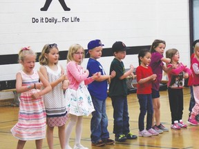 Mrs. Weir's Grade 1 class at Evergreen School performs a dance they learned during the talent show in the school gymnasium.