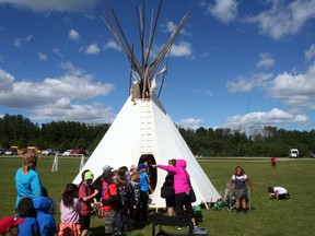 Students line up outside a teepee set up at Rotary Park for National Aboriginal Day on June 21 (Jeremy Appel | Whitecourt Star).