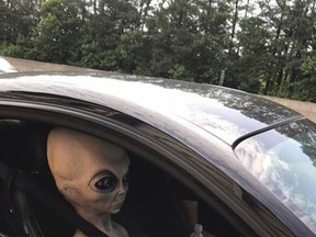 In this Sunday, June 25, 2017 photo provided by the Alpharetta Department of Public Safety an alien figure sits in the passenger seat of a vehicle that was pulled over north of Atlanta, Ga. (Alpharetta Department of Public Safety via AP)