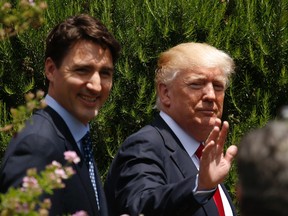 U.S. President Donald Trump and Canadian Prime Minister Justin Trudeau, left, are seen following a family photo of G7 leaders and Outreach partners at the Hotel San Domenico during a G7 summit in Taormina, Italy, Saturday, May 27, 2017. (Jonathan Ernst/Pool photo via AP)