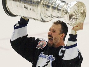 Tampa Bay Lightning captain Dave Andreychuk hoists the Stanley Cup after the Lightning defeated the Calgary Flames to win the Stanley Cup in Tampa on June 7, 2004. (THE CANADIAN PRESS/AP/Gene J. Puskar)