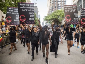 People from the Blacks Lives Matter movement march during the Pride parade. (THE CANADIAN PRESS)