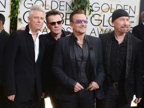 This Jan. 12, 2014 file photo shows members of the Irish rock band U2, from left, Adam Clayton, Larry Mullen, Jr., Bono, and The Edge at the 71st annual Golden Globe Awards at the Beverly Hilton Hotel in Beverly Hills, Calif. Clayton thanked his bandmates on Monday, June 26, 2017, for their support during his treatment and recovery from alcohol abuse years ago, before joining them for a rollicking rendition of a few hits. Clayton received an award Monday at a Manhattan theater from MusiCares, a foundation that helps musicians get treatment for addiction. (Photo by Jordan Strauss/Invision/AP, File)