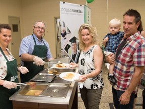 Line Hache, left, director of sales support at Voyageurs Credit Union, Robert Boucher, board president of Voyageurs Credit Union, serve breakfast to Marie-Eve Pepin, Lucas Vaillancourt-Pepin and Brian Vaillancourt. Supplied photo
