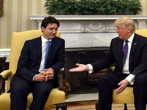 Prime Minister Justin Trudeau meets with US President Donald Trump in the Oval Office of the White House in Washington, D.C., on Feb. 13, 2017. The Trump administration says it won't be swayed by trade threats from the Canadian government, after the northern neighbour warned it could start targeting American industries if the softwood lumber dispute drags on. (Sean Kilpatrick/THE CANADIAN PRESS)