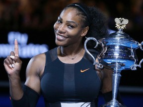 In this Jan. 28, 2017, file photo, Serena Williams holds up a finger and her trophy after defeating her sister, Venus, in the women's singles final at the Australian Open tennis championships in Melbourne, Australia. Williams posed nude for the cover of Vanity Fair in an image released by the magazine on June 27, 2017. (AP Photo/Aaron Favila, File)